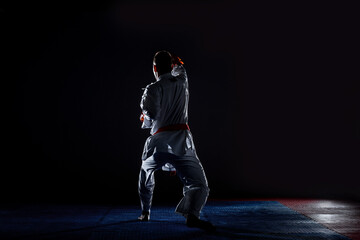 The karate guy in white kimono and red belt training karate