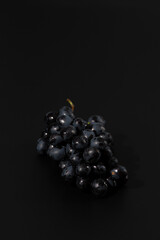 black grapes on a black background, low key