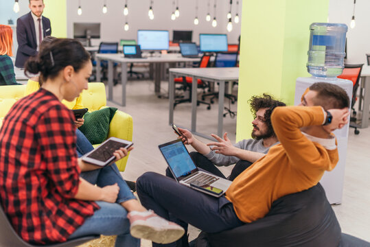 Multiethnic group of employees working in a google environment company. Group of colleagues working on a project in modern offices