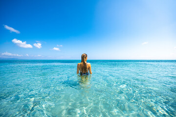 A girl bathing in Stintino beach called "La Pelosa". Stintino, Sassari province, Sardinia, Italy.