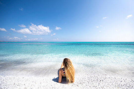 A girl bathing in Stintino beach called "La Pelosa". Stintino, Sassari province, Sardinia, Italy.