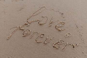 lettering love forever on the beach sand
