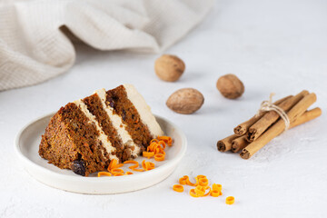 A piece of carrot cake with cinnamon and walnuts on a plate. Sugar, gluten, lactose free, vegan, healthy food.