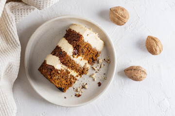 A piece of carrot cake with cinnamon and walnuts on a plate. Horizontal orientation, top view. Sugar, gluten, lactose free, vegan, healthy food.