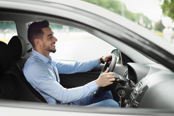 Attractive arabic guy enjoying driving, going to job