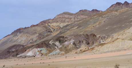 Naklejka na ściany i meble Vie of Artist's Palette in Death Valley National Park showing layers of multicolored minerals exposed by erosion.