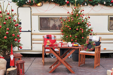 Christmas tree background. Van mobile trailer, mobile home, terrace. New Year celebration. Winter holidays. Christmas morning. Camper van in camp ground, caravan van.