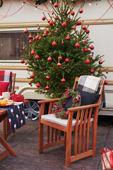 Christmas tree background. Van mobile trailer, mobile home, terrace. New Year celebration. Winter holidays. Christmas morning. Camper van in camp ground, caravan van.