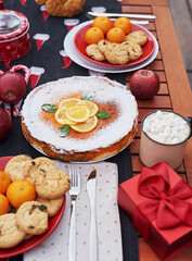 Christmas pie, cocoa with marshmallows and table. Christmas tree background. Van mobile trailer, mobile home, terrace. New Year celebration. Winter holidays. Christmas morning.