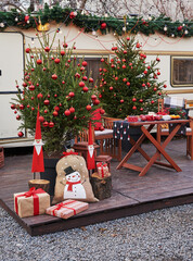 Christmas tree background. Van mobile trailer, mobile home, terrace. New Year celebration. Winter...