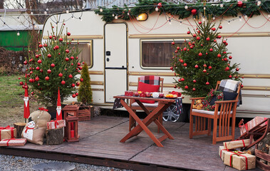 Christmas tree background. Van mobile trailer, mobile home, terrace. New Year celebration. Winter...