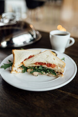 Turkey and tomato sandwich on a plate. Breakfast