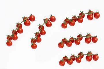Cluster of fresh red cherry tomatoes isolated on a white background. 