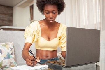 Fototapeta na wymiar portrait of African American black woman, freelancer, working from home. laptop