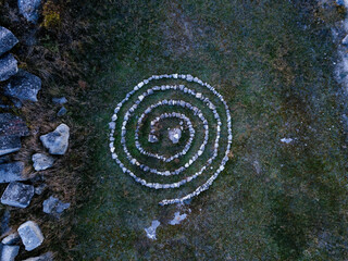 Spiral labyrinth made of stones, top view from drone