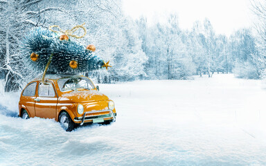 Winter scenery with yellow car carrying christmas tree on roof