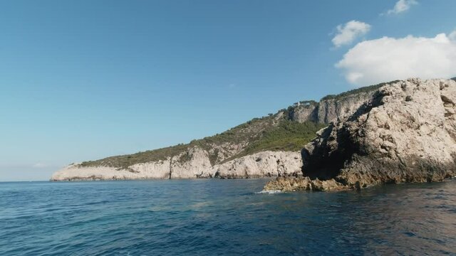 Capri Island cliff sea shores, ighthouse, view from speed boat, editorial image