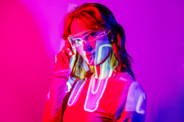 Young Woman In Projector Lights with led futuristic glasses