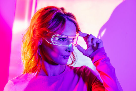 Stylish Woman In Neon Lights with led googles