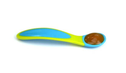 Baby fruit puree in spoon isolated on white.