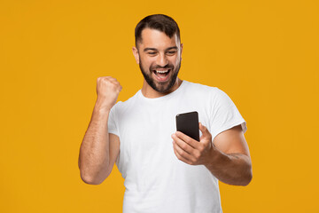 Satisfied happy adult european man feeling euphoric, enjoying good message and online victory
