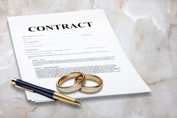 Two wedding rings on a blank marriage contract at a traditional wedding.