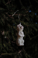 The dog on the fir. Vintage Christmas tree toy decoration in the Soviet Union appeared after the flight of dogs Whitey and Arrow (Belka and Strelka) into space in 1960. Vertical image. Dark photo. 