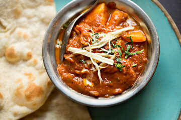 Masala paneer cheese curry with indian flatbread
