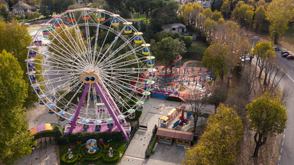 Aerial view of a ferris wheel inside Rome amusement park, located in the Eur district. There is no...