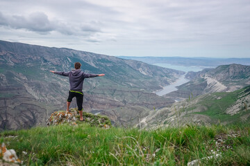 Fototapeta na wymiar Hiker on top of a mountain in Sulak canyon