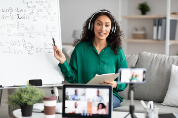 Female teacher in headset explaining math online making videocall - obrazy, fototapety, plakaty