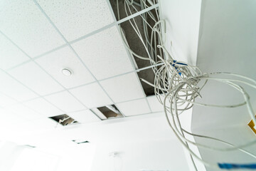 Fototapeta na wymiar Renovation wire from ceiling. Electrical cables instalation.
