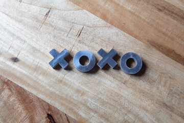 XOXO Hugs and Kisses message on wood background