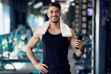 Handsome Young Arab Male Athlete Posing At Gym While Resting After Training
