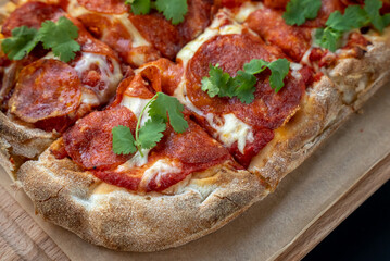 Tasty pizza on black background. Delicious pepperoni pizza.  Enjoying time with friends and tasty food.