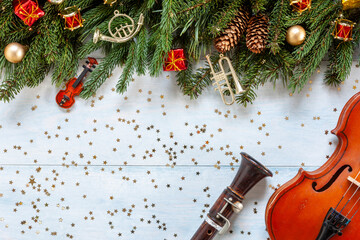 Old violin and flute with fir-tree branches with Christmas decor. Christmas and New Year's concept....