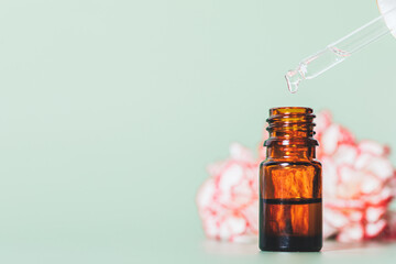 Essential oil dripping from pipette