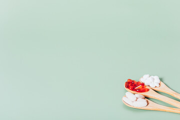 Close-up medical pills and capsules in wooden spoons