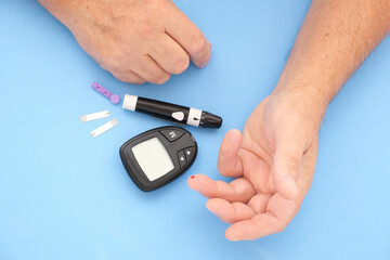 Old man measures blood sugar