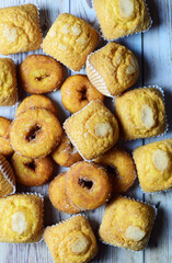 Vertical shot, sugared muffins and doughnuts, sweet background.
