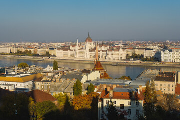 Fototapeta na wymiar Panoramic view of the Parliament building and Budapest. Colorful autumn view in Budapest, Hungary, Europe.