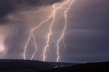 Fototapeta na wymiar Huge lightnings at night with landscape