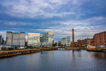 Liverpool, England. September 30, 2021. River mersey with embankment and modern city buildings against cloudy sky