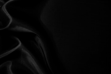 Part of the dark fabric texture of the fabric for the background and decoration of the work of art, a beautiful crumpled pattern of silk or linen. A crumpled piece of cloth