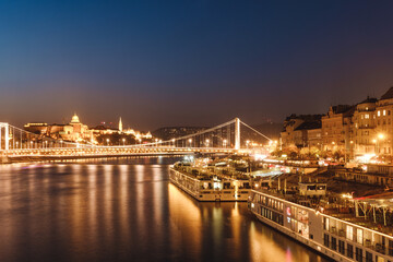 A panoramic view of the bridge and buildings in Budapest. Colorful evening view in Budapest, Hungary, Europe.