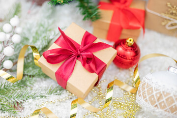 Christmas decor with decorations balls on a Christmas tree with serpentine and gift boxes with surprises