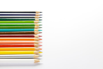 Colored pencils isolated on a white background. Place for text. Copy space
