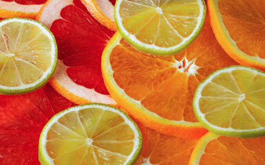 Background of round slices of orange, grapefruit and lime. Fruits, healthy food.