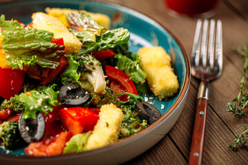 Gourmet salad with fried feta cheese and lettuce leaves