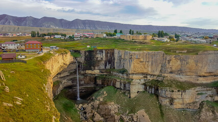 A picturesque waterfall falling into a deep canyon. Republic of Dagestan, Russia.